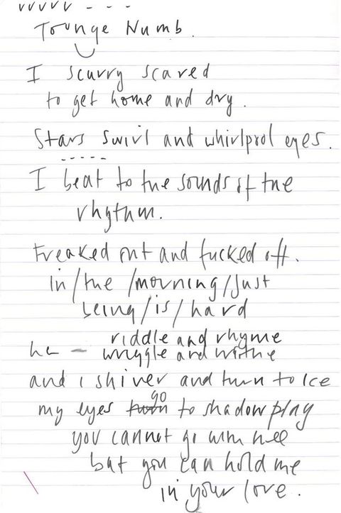 Colour photograph. White notepaper with pale red printed lines and handwritten notes in black ink across the page. Writing slopes slightly towards the right and covers most of the page, a diagonal red ink line echoes the flow of writing in the lower-left corner.